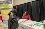 Quentella Perry, a lifelong Milwaukee resident and licensed health insurance navigator at Covering Wisconsin, answers basic questions about coverage and enrollment at a March 19 outreach event. Photo provided by Covering Wisconsin.