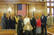 Dr. William Finlayson (center) poses with family members, fraternity brothers and council members following vote to rename N. 5th St. in his honor. Photo by David Kuta, Milwaukee City Clerk's Office.