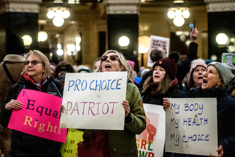 Protesters chant inside the Wisconsin state Capitol while holding signs Sunday, Jan. 22, 2023, in Madison, Wis. Angela Major/WPR