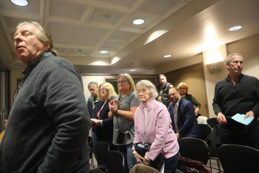 Brookfield residents stand to applause and show their support for Ald. Kris Seals, and their opposition to the affordable housing project. Photo by Isiah Holmes/Wisconsin Examiner.