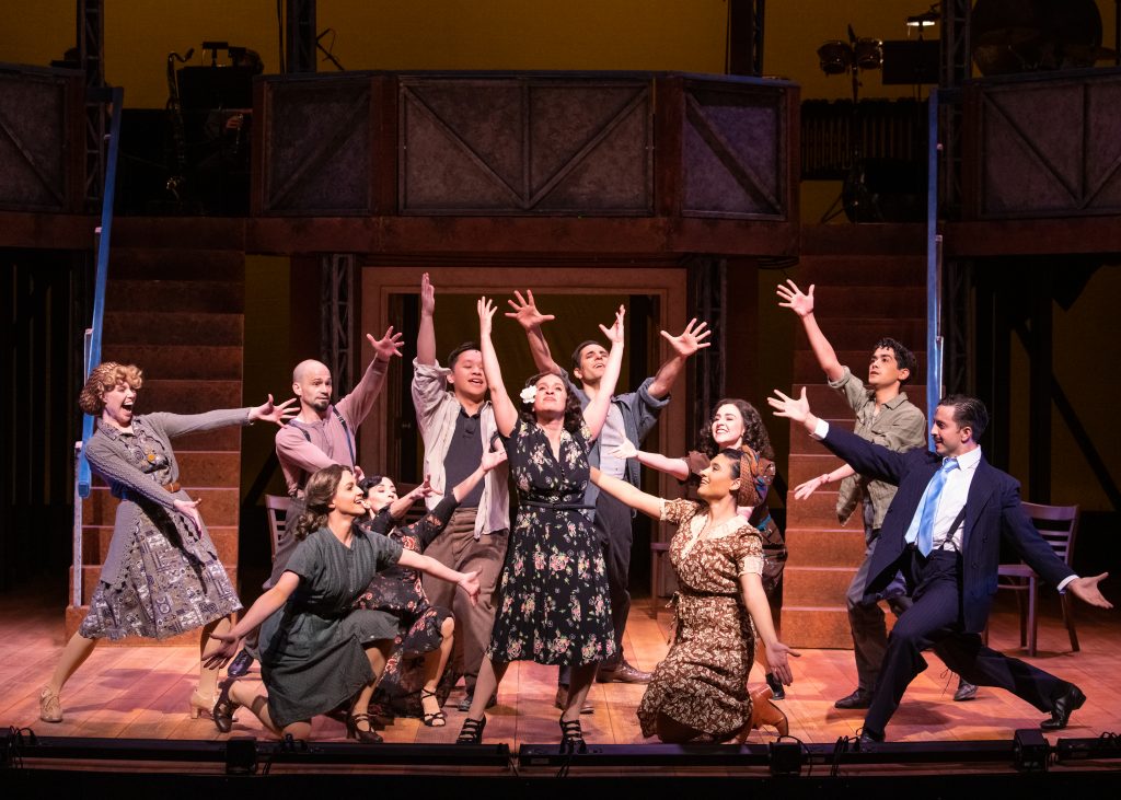 Rána Roman (center, floral dress) and the cast of Skylight Music Theatre’s production of Evita. Photo by Mark Frohna.