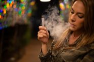 A female vapes with her JUUL e-cigarette. Photo by Sarah Johnson, CC BY 2.0 via Wikimedia Commons