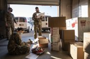 Members of the Wisconsin National Guard load boxes with hand warmers and PPE on Monday, Dec. 21, 2020, before distributing them to COVID-19 testing sites across the state. Angela Major/WPR