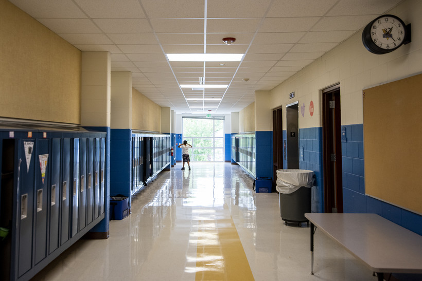 A student walks down a hallway with lockers Friday, Sept. 17, 2021, at Hackett Elementary School in Beloit, Wis. Angela Major/WPR