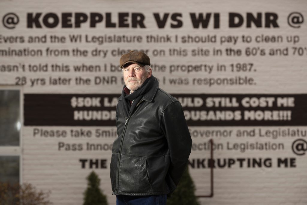 Ken Koeppler is being held liable for contamination beneath a building he owns in Madison, Wis., despite the fact he was never involved in the dry cleaning business that operated there in the 1950s and 1960s. “I was in grade school when these people were dumping chemicals there,” Koeppler says. The building had been converted into residential housing before he purchased it in the 1980s. He is shown Nov. 29, 2021 in Madison, Wis. (Mark Hoffman / Milwaukee Journal Sentinel)
