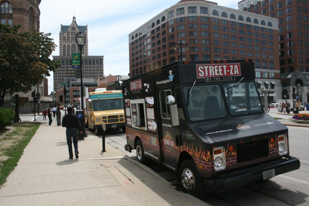 Food trucks parked on N. Water St. near Red Arrow Park as part of the former Food Truck Friday event. Photo by Dave Reid.