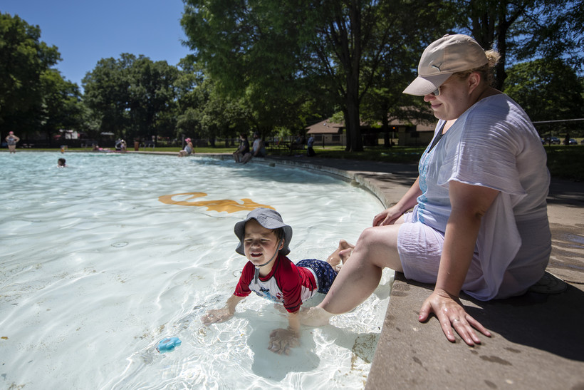 Brittany Caple, right, and her 3-year-old son, Abraham, cool off in the pool Monday, June 20, 2022, at Palmer Park in Janesville, Wis. Angela Major/WPR