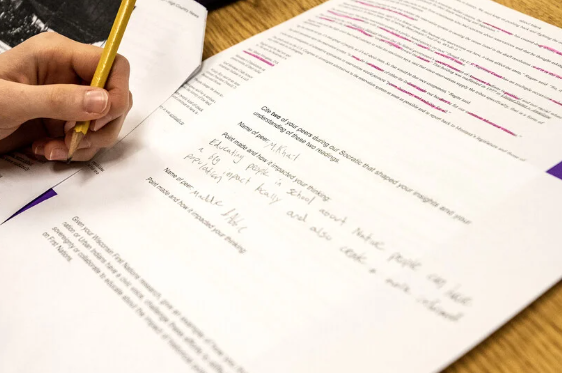 Eleventh-grader Sophie Leamy writes notes during a discussion Tuesday, Jan 17, 2023, at Madison West High School in Madison, Wis. Angela Major/WPR