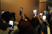 As Capitol police officers move to block the doors to the JFC meeting, protesters pull out their phones to record. Photo by Henry Redman/Wisconsin Examiner.