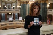 Sheila Lockwood holds a photo of her late son, Austin, in the Wisconsin State Capitol in Madison, Wis. In 2018, Austin, 23, was riding in the passenger seat of a drunk driver’s vehicle in Three Lakes, Wisconsin. The driver smashed into a tree, killing Austin. (Drake White-Bergey / Wisconsin Watch)