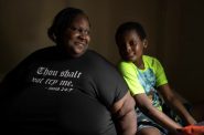 Deanna Branch sits with her son Aidan, now 10, in the bedroom of a Milwaukee apartment they were moving out of on July 1, 2023. Beginning in 2015 Aidan was twice sent to Children’s Wisconsin hospital with severe lead poisoning due to hazards in a previous aging rental in Milwaukee. (Sara Stathas for Wisconsin Watch)