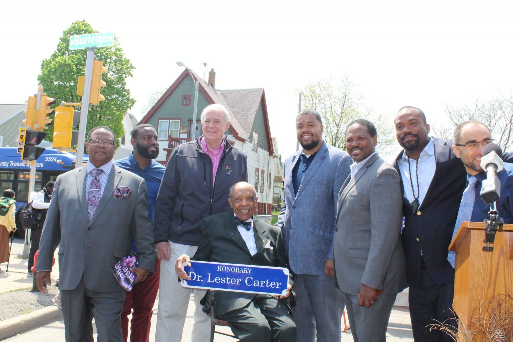 Dr. Lester Carter poses with then-Mayor Tom Barrett, Ald. Khalif Rainey, then Council President Ashanti Hamilton, Ald. Russell W. Stamper, II and others at his 2018 street renaming ceremony. Photo from the City of Milwaukee Public Information Division.