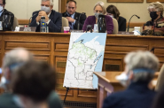 A map created by Republicans in the state Legislature is displayed during a hearing on Oct. 28, 2021, at the Wisconsin State Capitol. Sen. Jeff Smith sits on the left. Angela Major/WPR