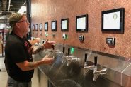 Tim Eichinger, owner of Black Husky Brewing, uses a tap at City Fountain. Photo taken Sept. 21, 2023 by Sophie Bolich.
