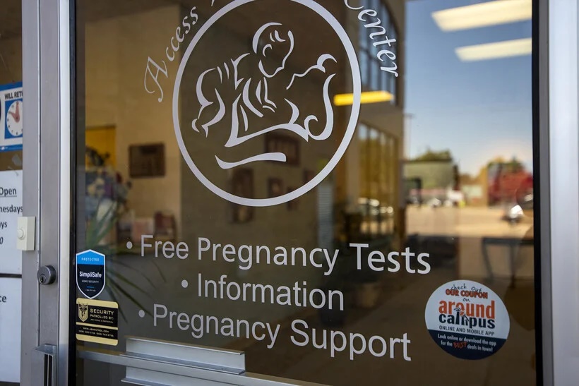 The door to Access Women's Center displays services the nonprofit pregnancy center offers Tuesday, Aug. 30, 2022, in Madison, Wis. Angela Major/WPR