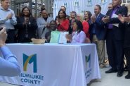 Milwaukee County Executive David Crowley and Board Chairwoman Marcelia Nicholson hold signed 2024 budget. Photo by Graham Kilmer.