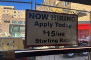A help wanted sign at a Madison grocery store next to a construction site. Joe Tarr/ WPR