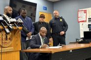 Milwaukee Mayor Cavalier Johnson signs a resolution Monday which calls on state lawmakers to allow the city to take additional measures to tackle reckless driving. Evan Casey/WPR