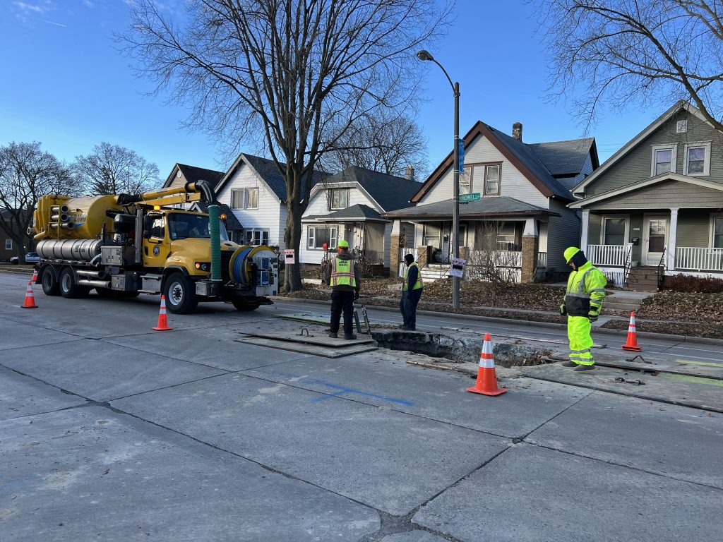 Department of Public Works employees work on a sewer on S. Howell Ave. Photo by Jeramey Jannene.