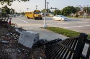 Vehicles drive Wednesday, Sept. 14, 2022, past a fence that was damaged during a crash on W Fond du Lac Ave. and W Congress St. in Milwaukee, Wis. Angela Major/WPR