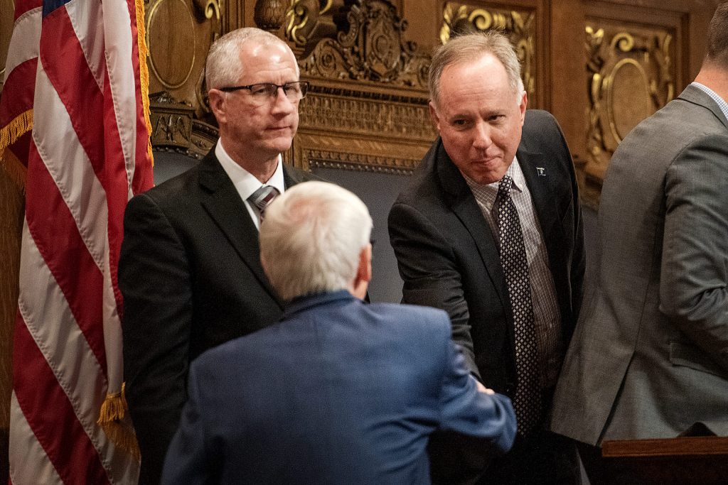 Assembly Speaker Robin Vos, right, shakes hands with Gov. Tony Evers before the State of the State address Tuesday, Jan. 23, 2024, at the Wisconsin State Capitol in Madison, Wis. (Angela Major/WPR)