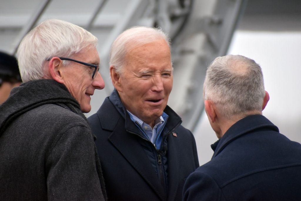 President Joe Biden greets Minnesota Gov. Tim Walz and Wisconsin Gov. Tim Evers after exiting Air Force One on Jan. 25, 2024 in Duluth. Danielle Kaeding/WPR