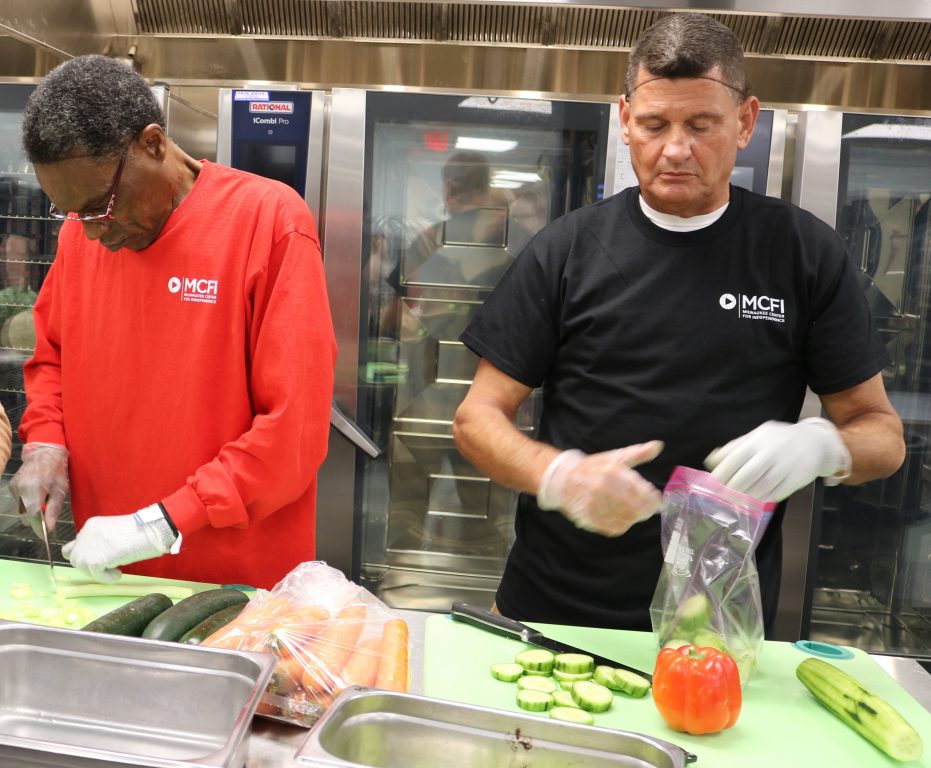 CFI's Food and Nutrition Service team members Stan Pinkney (left) and Hector Slawson work on their knife skills. Photo taken Feb. 15, 2024 by Sophie Bolich.