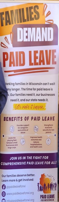  A banner promoting a paid family and medical leave proposal on display at a press conference in the Capitol Wednesday. (Wisconsin Examiner photo)