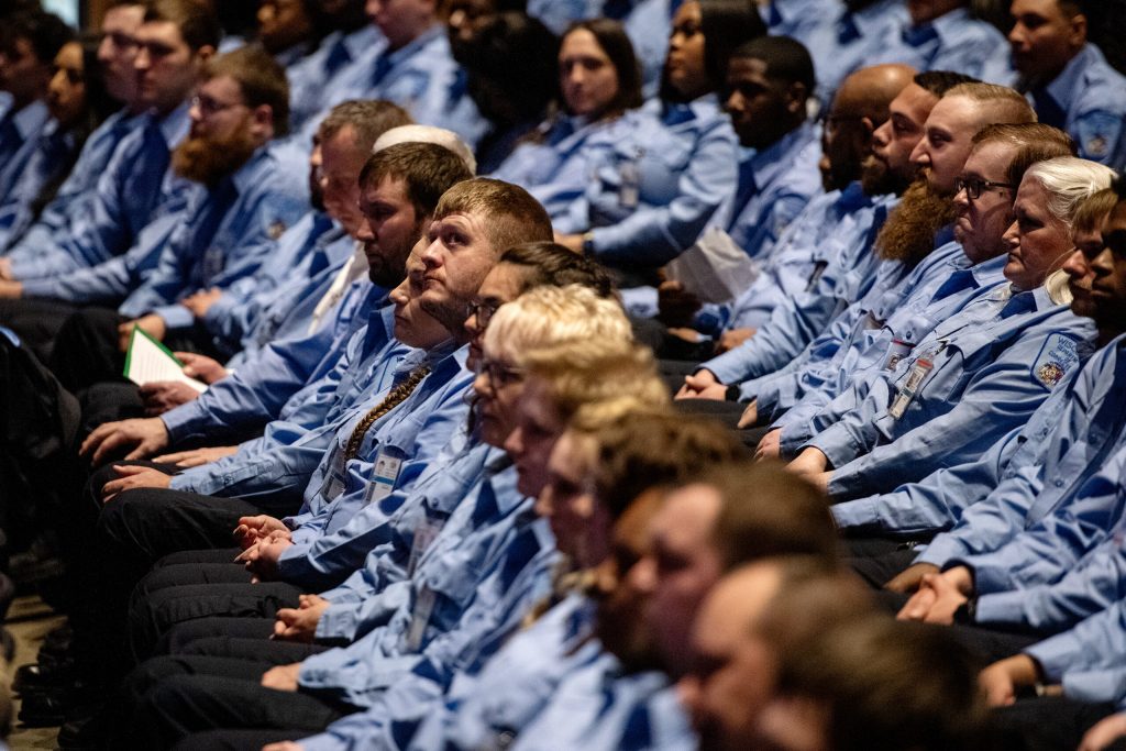 Corrections officer graduates sit at their graduation ceremony Wednesday, Feb. 21, 2024, at Madison Area Technical College in Madison, Wis. (Angela Major/WPR)