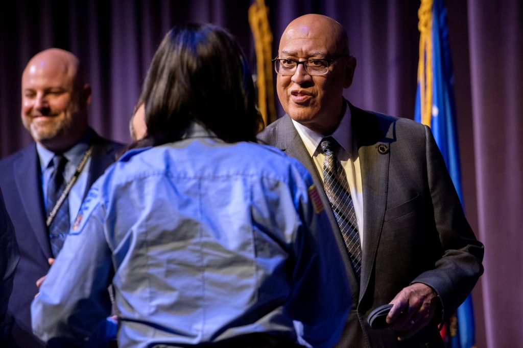 Secretary for the Wisconsin Department of Corrections Kevin Carr shakes hands with a graduate Wednesday, Feb. 21, 2024, at Madison Area Technical College in Madison, Wis. (Angela Major/WPR)