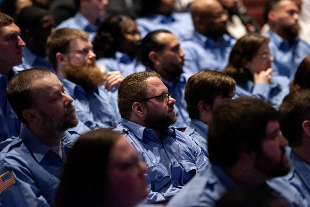 Corrections officer graduates sit during their ceremony Wednesday, Feb. 21, 2024, at Madison Area Technical College in Madison, Wis. (Angela Major/WPR)