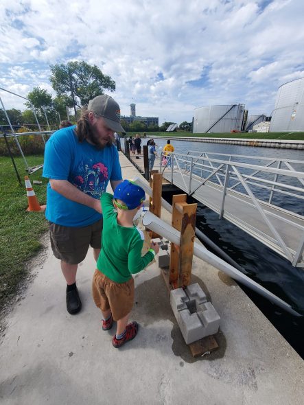 Jeff Mercer helps his son Lucas release a sturgeon down the halfpipe and into the Milwaukee harbor slip on Sept. 24, 2023. Photo courtesy Jamie Mercer.