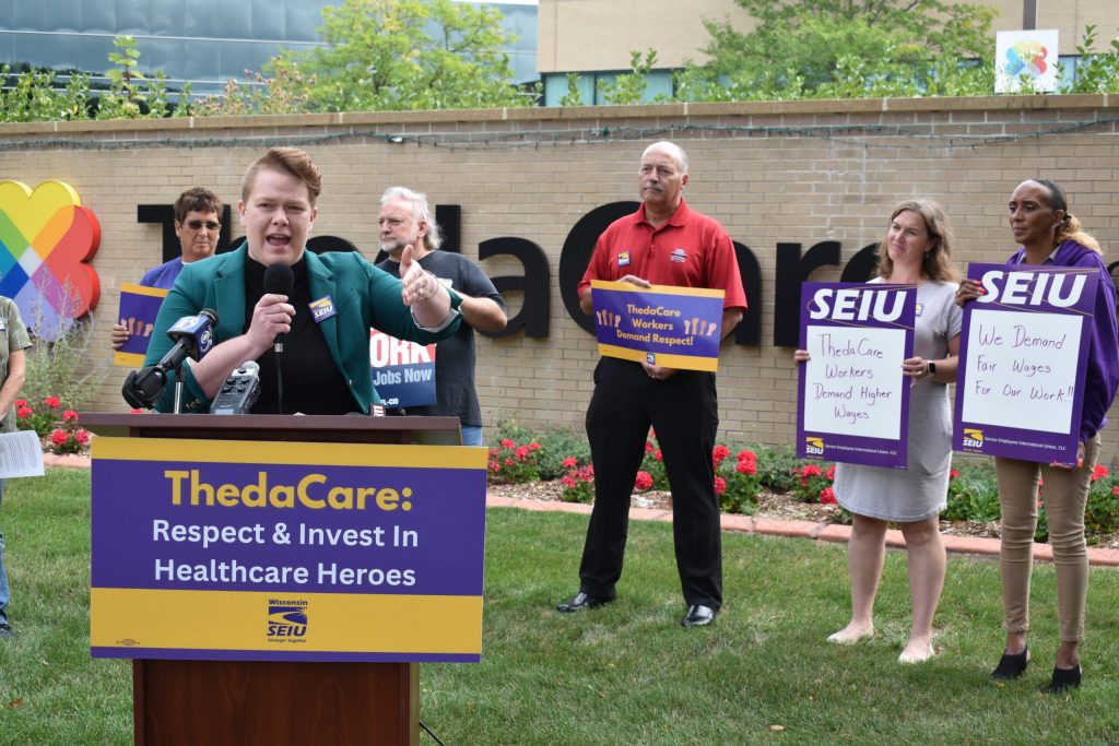The Rev. Hannah Roberts Villnave of the Fox Valley Unitarian Universalist Fellowship speaks from a podium outside ThedaCare Regional Medical Center–Appleton on Tuesday, Aug. 29., 2023. She supported the union and employees efforts to bargain for better pay. Joe Schulz/WPR