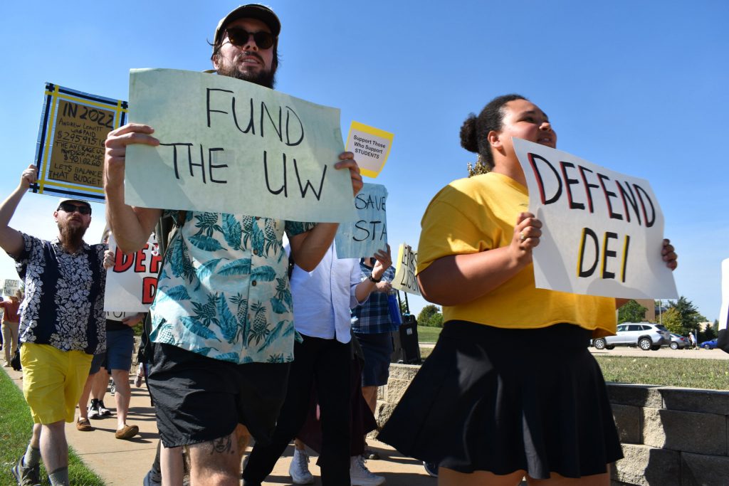 Dozens of UW-Oshkosh students, staff, faculty and community members march to protest the university’s plans to cut 200 positions to address its $18 million budget deficit. They also called on state Lawmakers to restore funding for the UW System. Joe Schulz/WPR