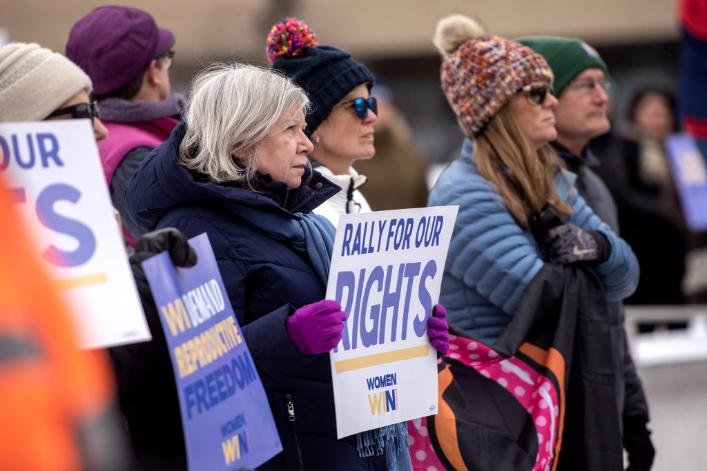 Supporters of abortion access hold signs at a rally Saturday, March 11, 2023, in Appleton, Wis. Angela Major/WPR