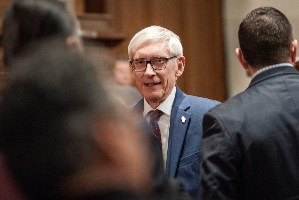 Gov. Tony Evers greets lawmakers before giving the State of the State address Tuesday, Jan. 23, 2024, at the Wisconsin State Capitol in Madison, Wis. (Angela Major/WPR)