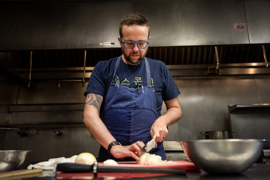 Dan Jacobs works in the kitchen Friday, March 1, 2024, at DanDan, a Milwaukee restaurant he co-owns. Angela Major/WPR