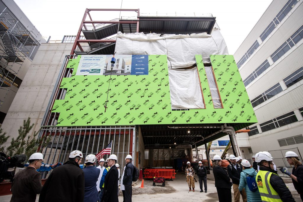 Attendees await a ceremonial lifting of the project’s final beam Thursday, March 7, 2024, at Froedtert & Medical College of Wisconsin in Milwaukee, Wis. Angela Major/WPR