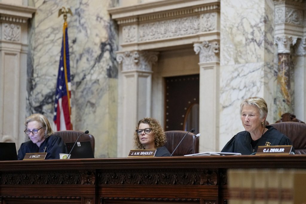 From left, Wisconsin Supreme Court justices Jill Karofsky, Rebecca Dallet and Ann Walsh Bradley — three of the court’s four liberal members — are shown on Sept. 7, 2023, at the Wisconsin State Capitol in Madison, Wis. (Andy Manis for Wisconsin Watch)