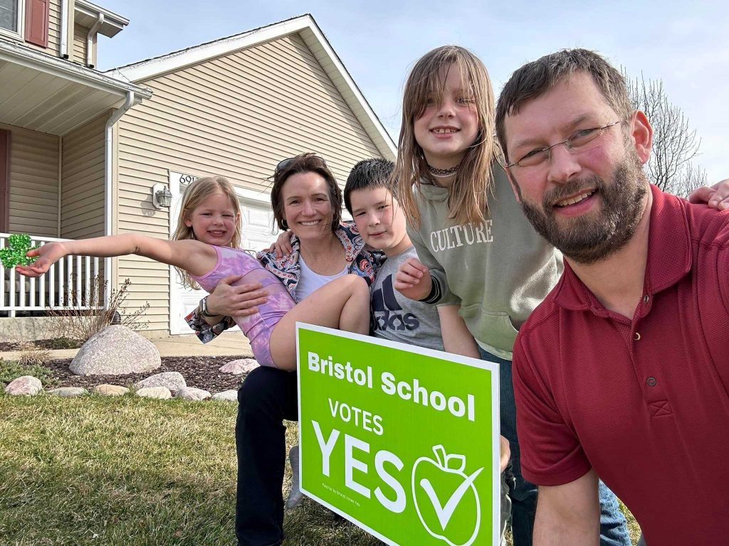 Matt Ley, a member of the “Bristol Votes Yes” committee, and his family in front of a yard sign. (Photo courtesy of Matt Ley)