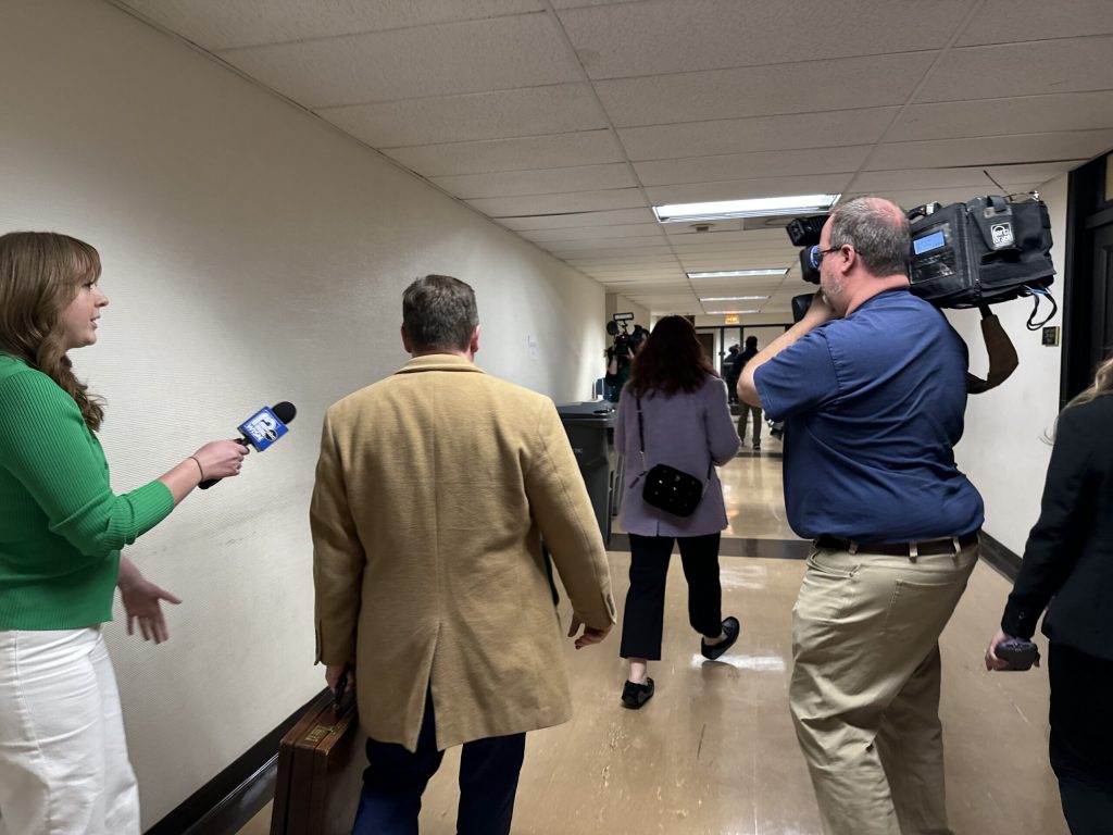 Kimberly Zapata (second from right) walks away from reporters at the Milwaukee County Public Safety Building on Wednesday, March 20, 2024. Evan Casey/WPR