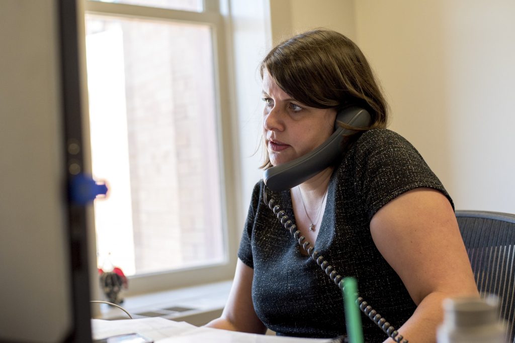 Claire Woodall-Vogg, executive director of the Milwaukee Election Commission, speaks on the phone from her office at City Hall during the partisan primary on Aug. 11, 2020. Will Cioci/Wisconsin Watch