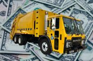 A Department of Public Works truck in front of dollar bills. Truck photo by Jeramey Jannene, cash photo is in the public domain.