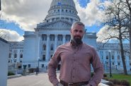 Former D.C. Metropolitan Police officer Michael Fanone, standing in front of the Wisconsin Capitol building, is touring the country to tell his story of being injured during the attack on the U.S. Capitol by supporters of Donald Trump on Jan. 6, 2021. (Erik Gunn | Wisconsin Examiner)