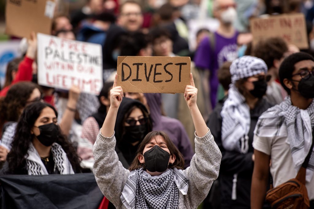 UW-Madison student Astrid Hooper Lofton holds a sign during a pro-Palestinian protest Monday, April 29, 2024, at the University of Wisconsin-Madison in Madison, Wis. Angela Major/WPR