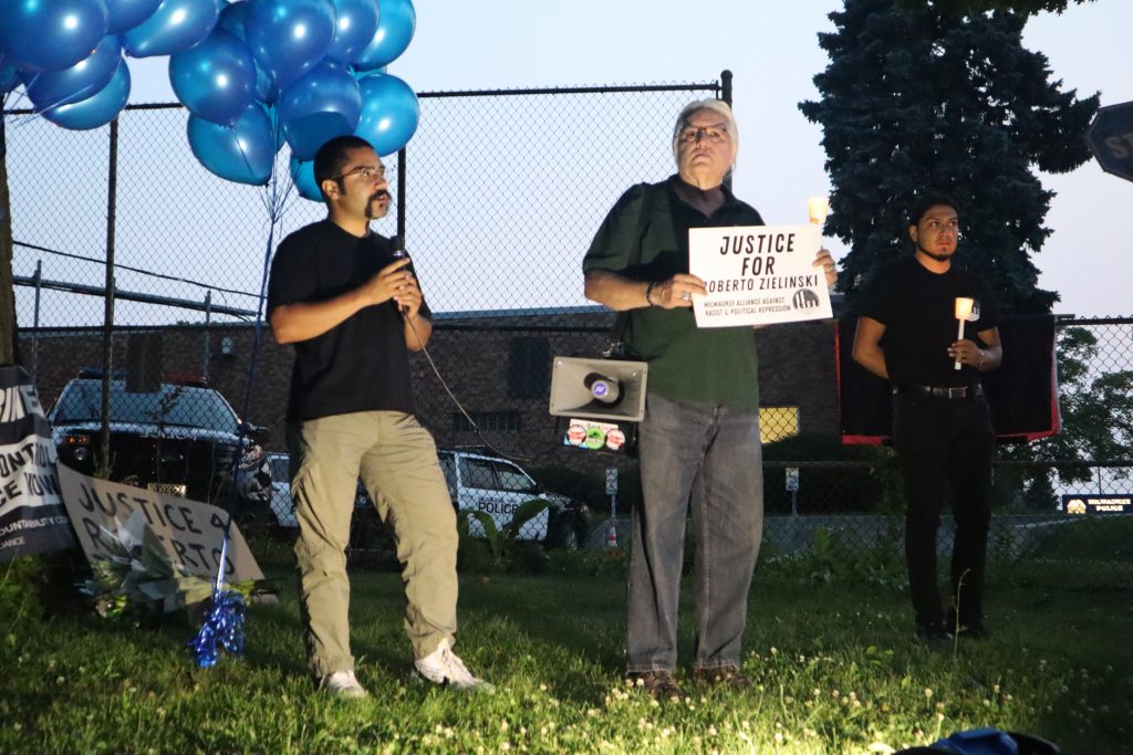 Omar Flores (left) stands alongside other members of the Milwaukee Alliance Against Racist and Political Repression at MPD’s District 2 station. (Photo | Isiah Holmes)