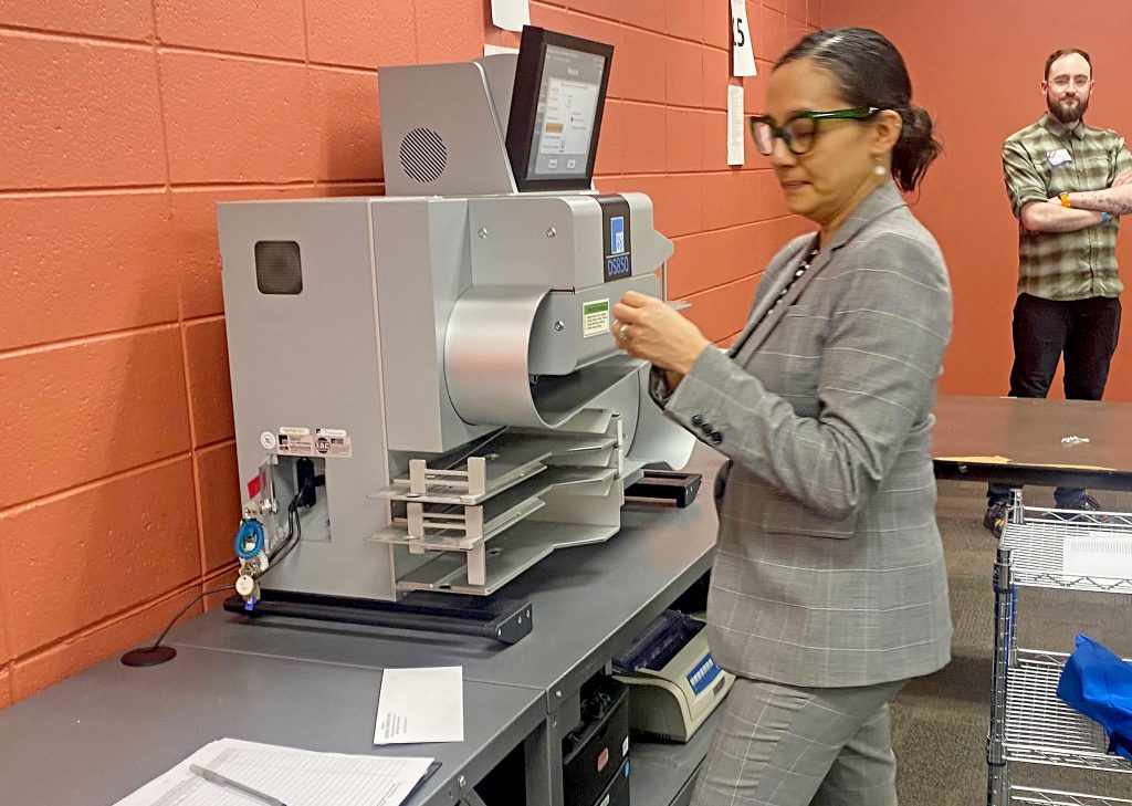 Milwaukee Election Commission Deputy Director Paulina Gutierrez prepares to export absentee ballot election results from a tabulator on April 2, 2024. (Alexander Shur / Votebeat)