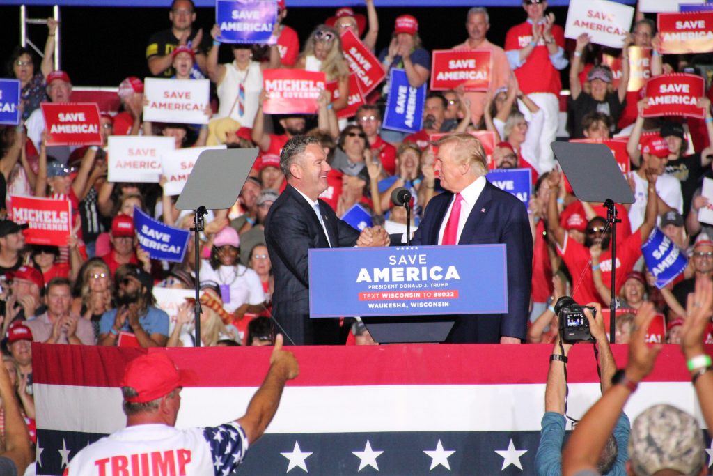 Republican candidate for governor Tim Michels shakes hands with former President Donald Trump at a Waukesha campaign rally on Aug. 5, 2022. Trump endorsed Michels in the Republican primary for governor. Shawn Johnson/WPR