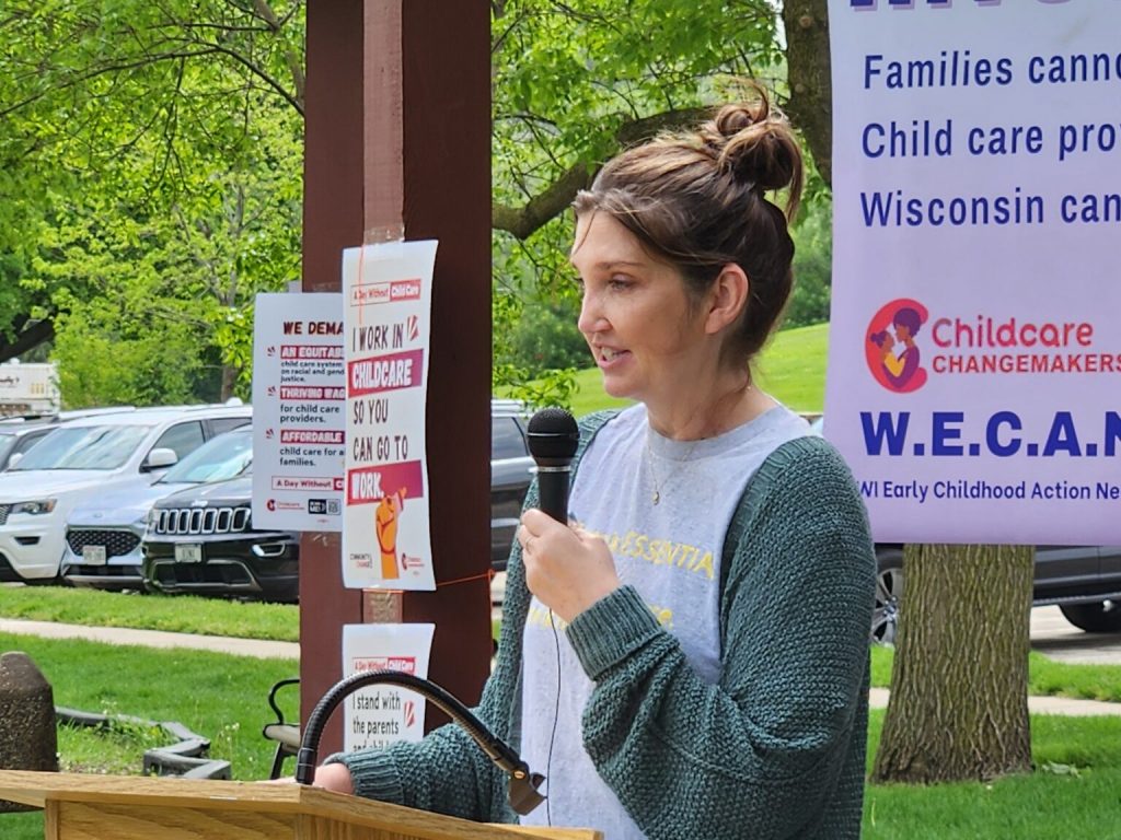 Brooke Legler, a child care provider and advocate, addresses a rally in New Glarus to call for public investment in child care. (Erik Gunn | Wisconsin Examiner)