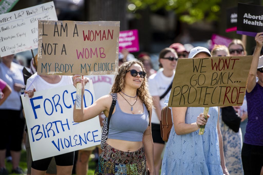 Protesters hold signs before a rally to support abortion access Saturday, May 14, 2022, at the Wisconsin state Capitol in Madison, Wis. Angela Major/WPR